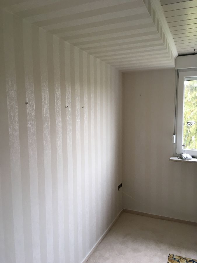 Tapezierarbeiten und gemusterten Teppichboden mit umlaufenden Fries verlegt